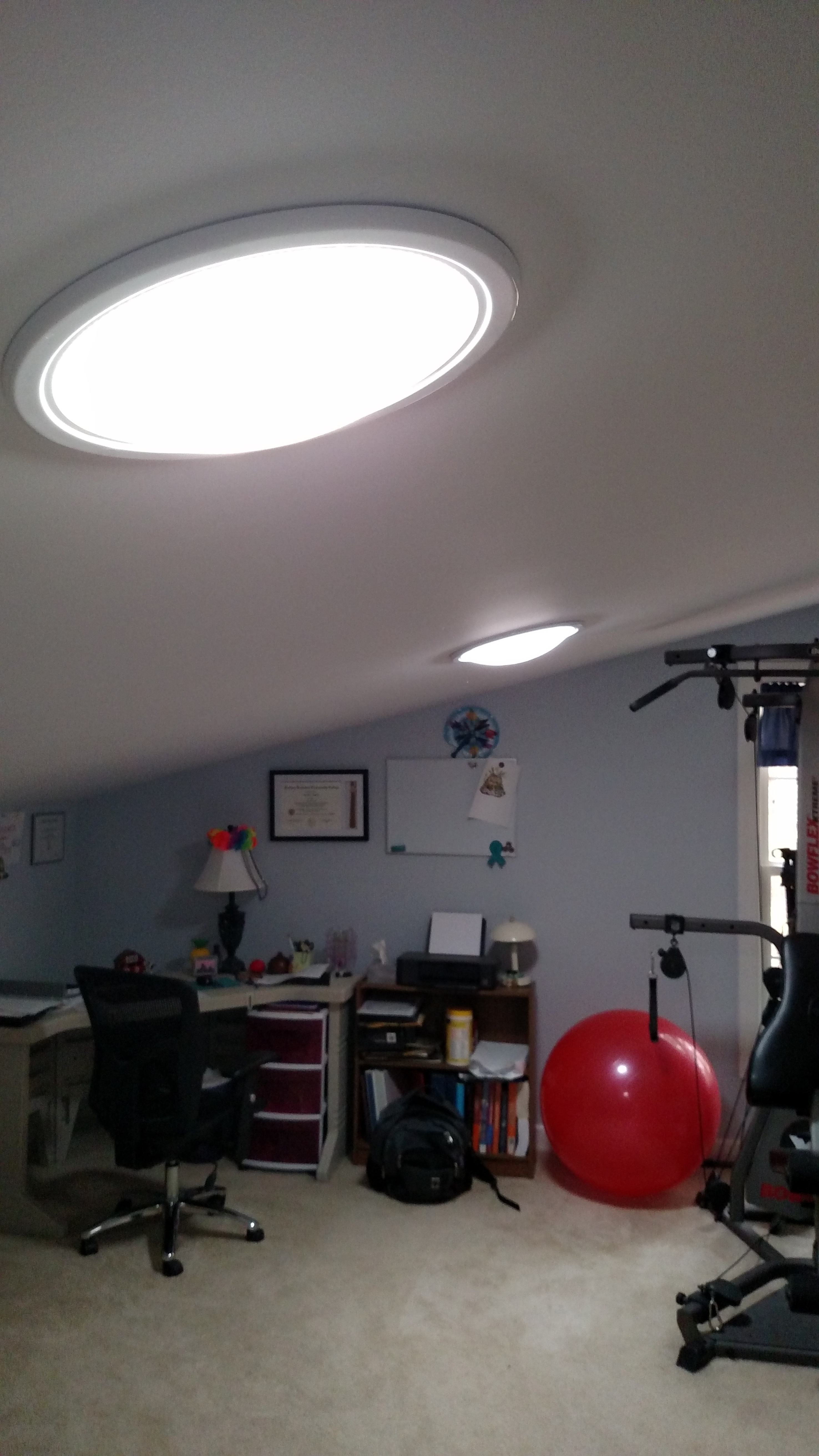 Workout room/office with solar lighting has equipment and desk set-up