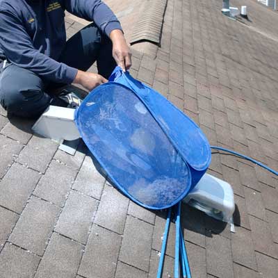 Tech Dryer Vent Cleaning from roof with blue bag to catch lint
